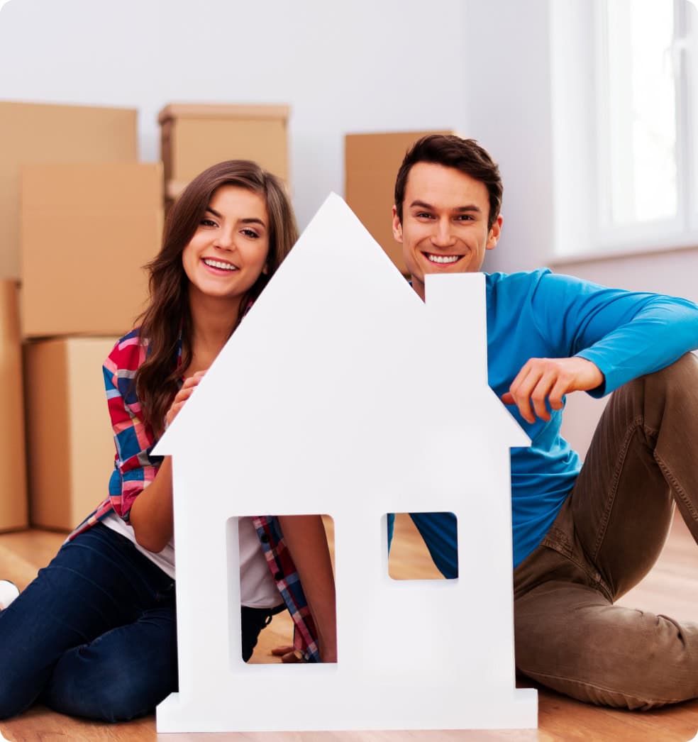 young-couple-with-house-sign